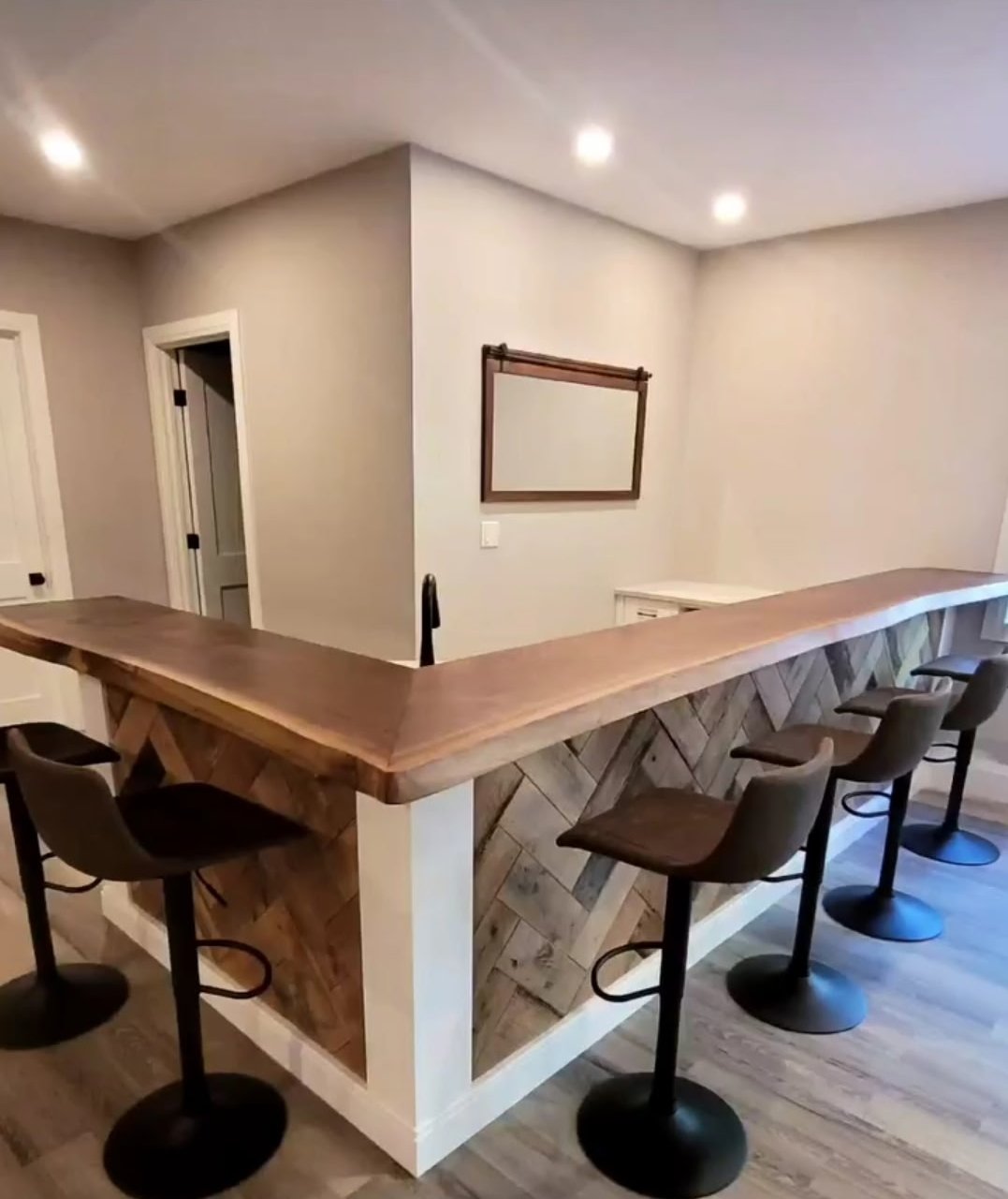 L-shaped home bar with live-edge walnut top and reclaimed herringbone panelling